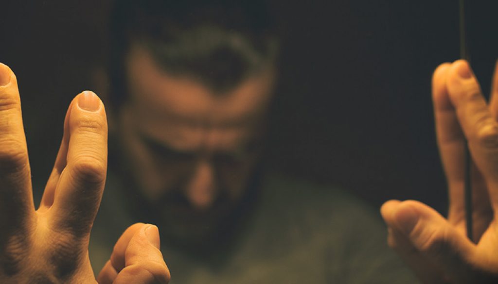 depression-man-reflection-hands